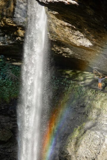 Dan stands behind the Berglistüber Waterfall after an easy hike to get there