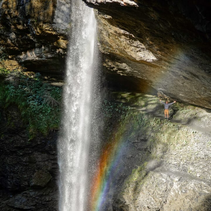 Dan stands behind the Berglistüber Waterfall after an easy hike to get there