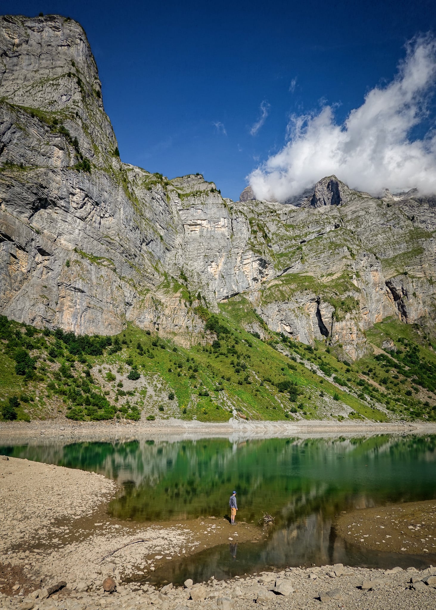 Dan stands near and admires Oberblegisee after doing a hike from Brunnenberg