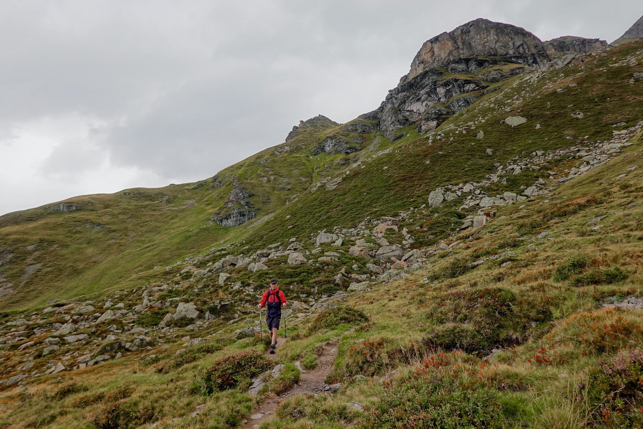 Dan walks in a mountainous landscape during the Kärpfwanderung