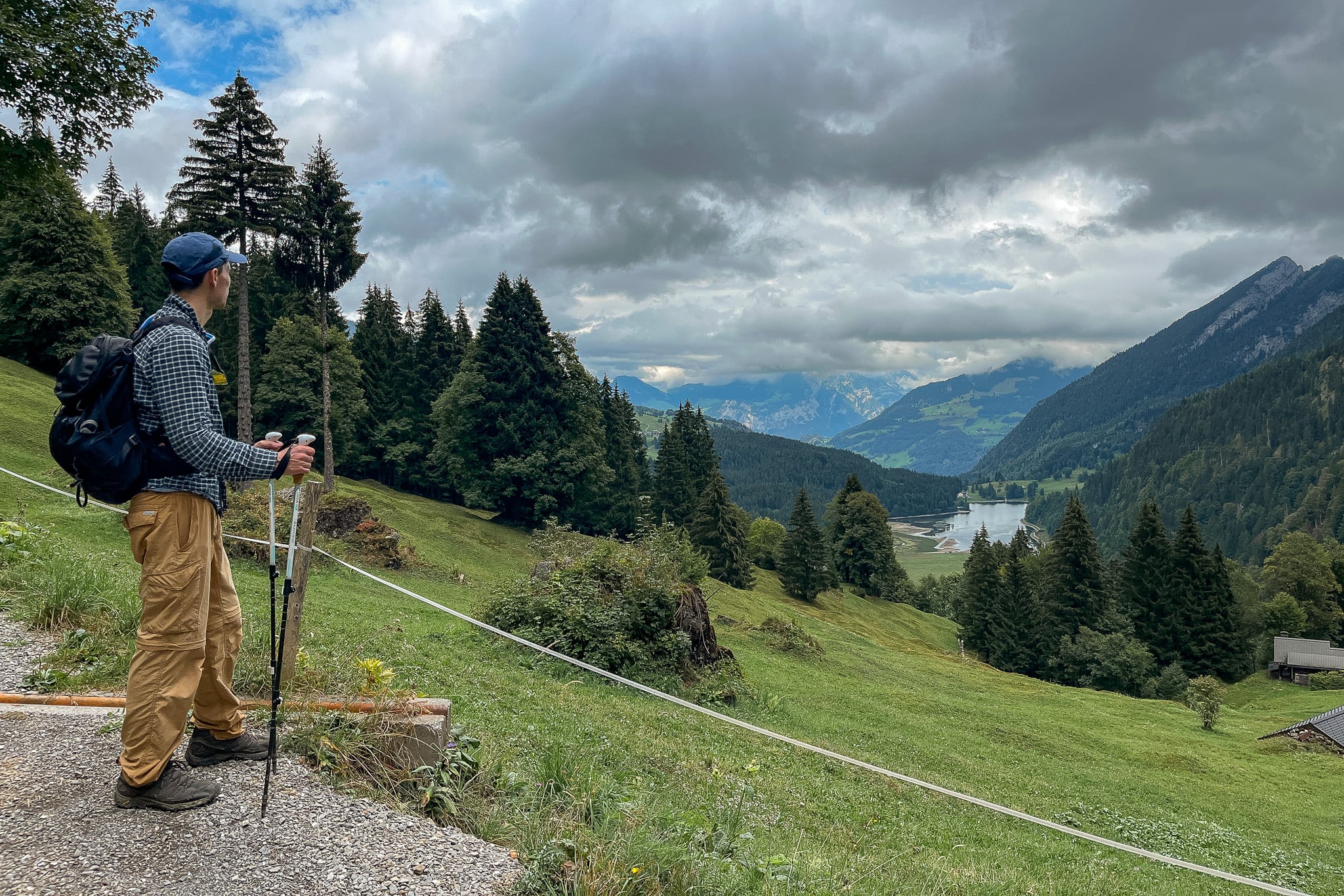 Dan looks towards a lake called Obersee Lake in an area called Näfels during a hike called Ahornen Rundweg