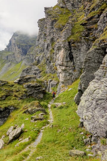 Dan walks in a mountainous landscape during a hike called Kärpfwanderung