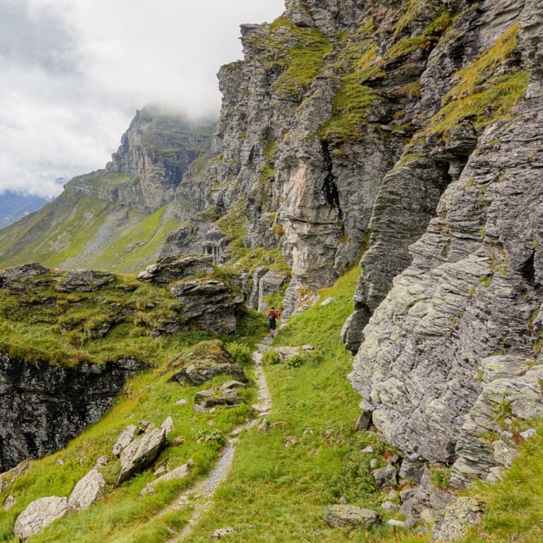Dan walks in a mountainous landscape during a hike called Kärpfwanderung