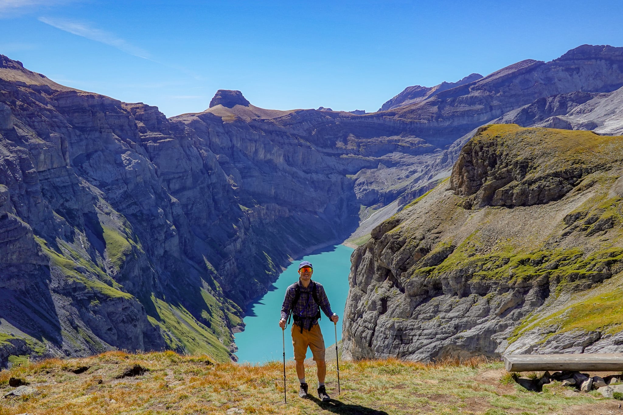 Dan stops during the Limmernsee Hike, where you can see Muttenchopf, Limmernsee and a mountain range in the background.