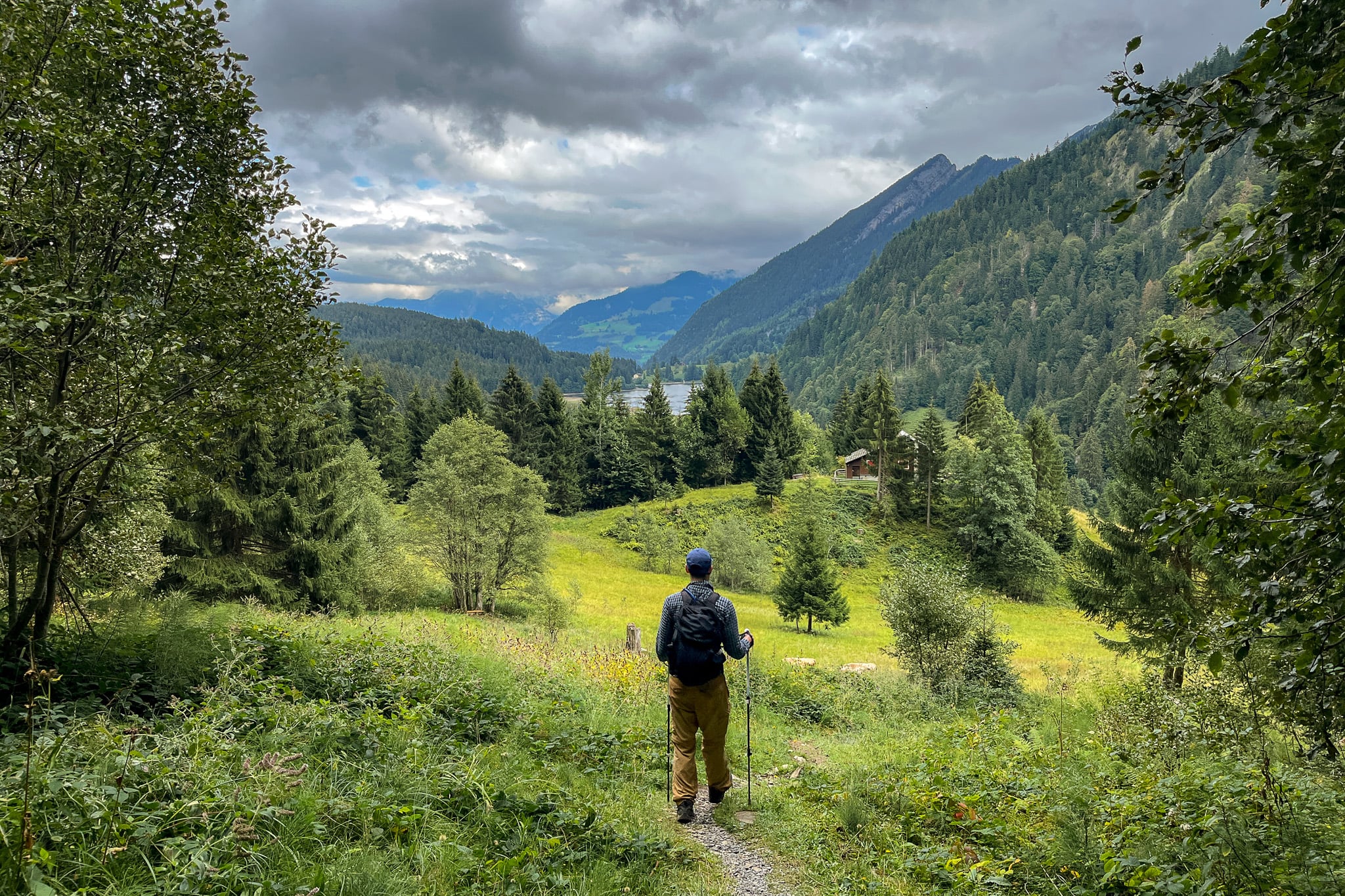Dan looks towards a lake called Obersee Lake in an area called Näfels during a hike called Ahornen Rundweg