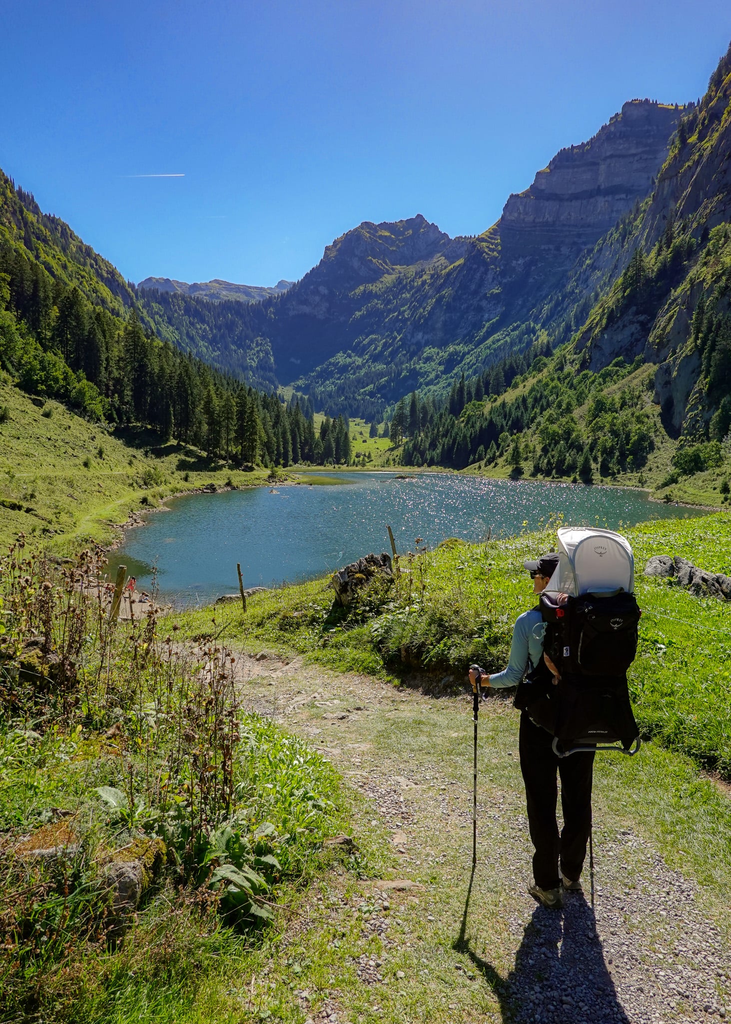 Beck looks at a lake surrounded by mountains during the Habergschwänd Talalpsee Hike