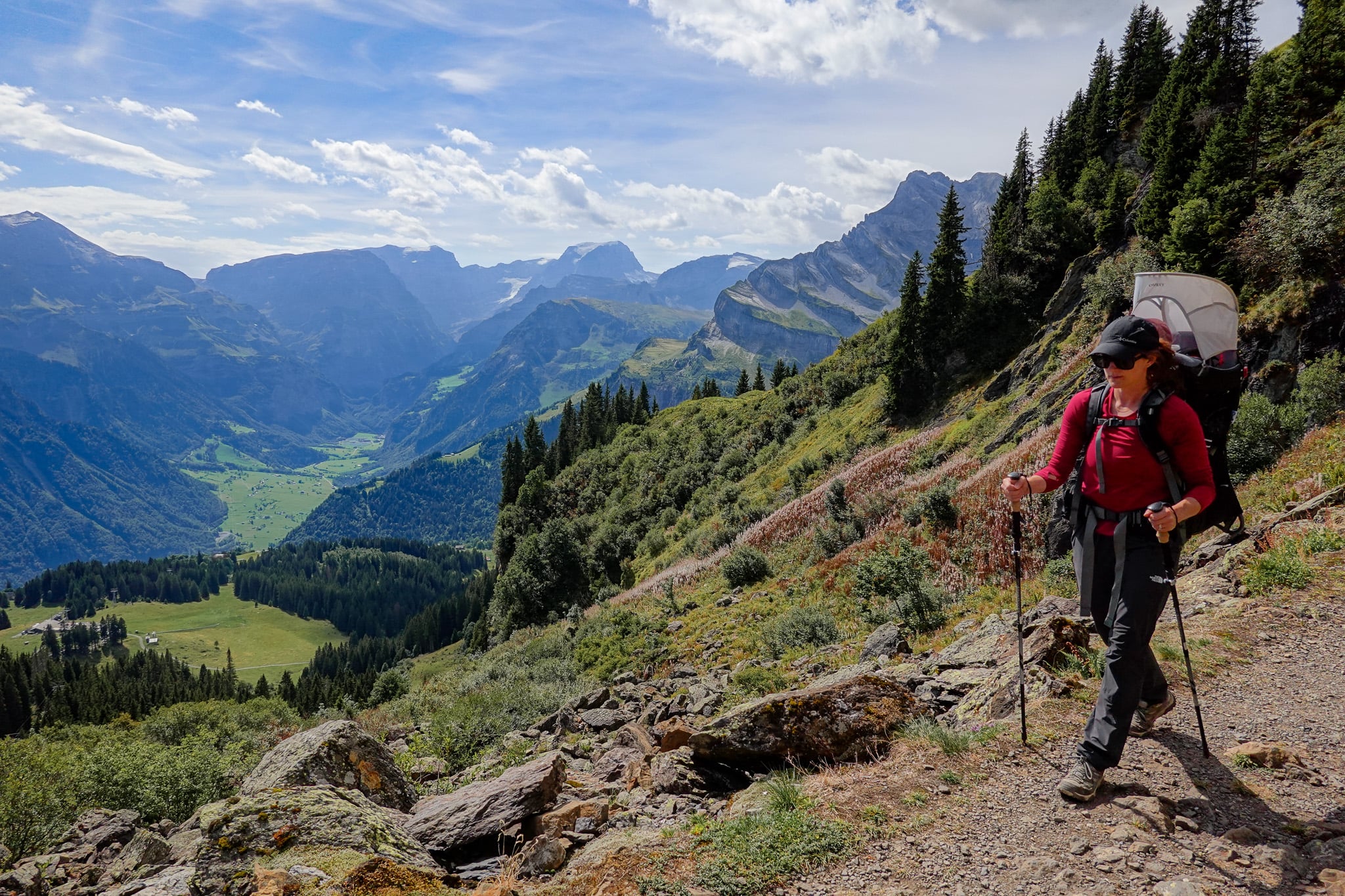 Beck walks on a trail amongst mountains during a hike called the Braunwald Panoramaweg