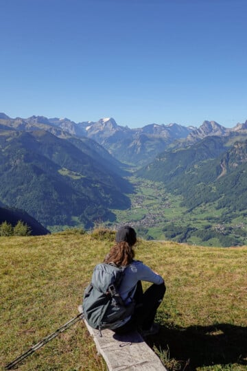 Beck sits and looks at views of mountains during a walk called Holzflue Rundweg