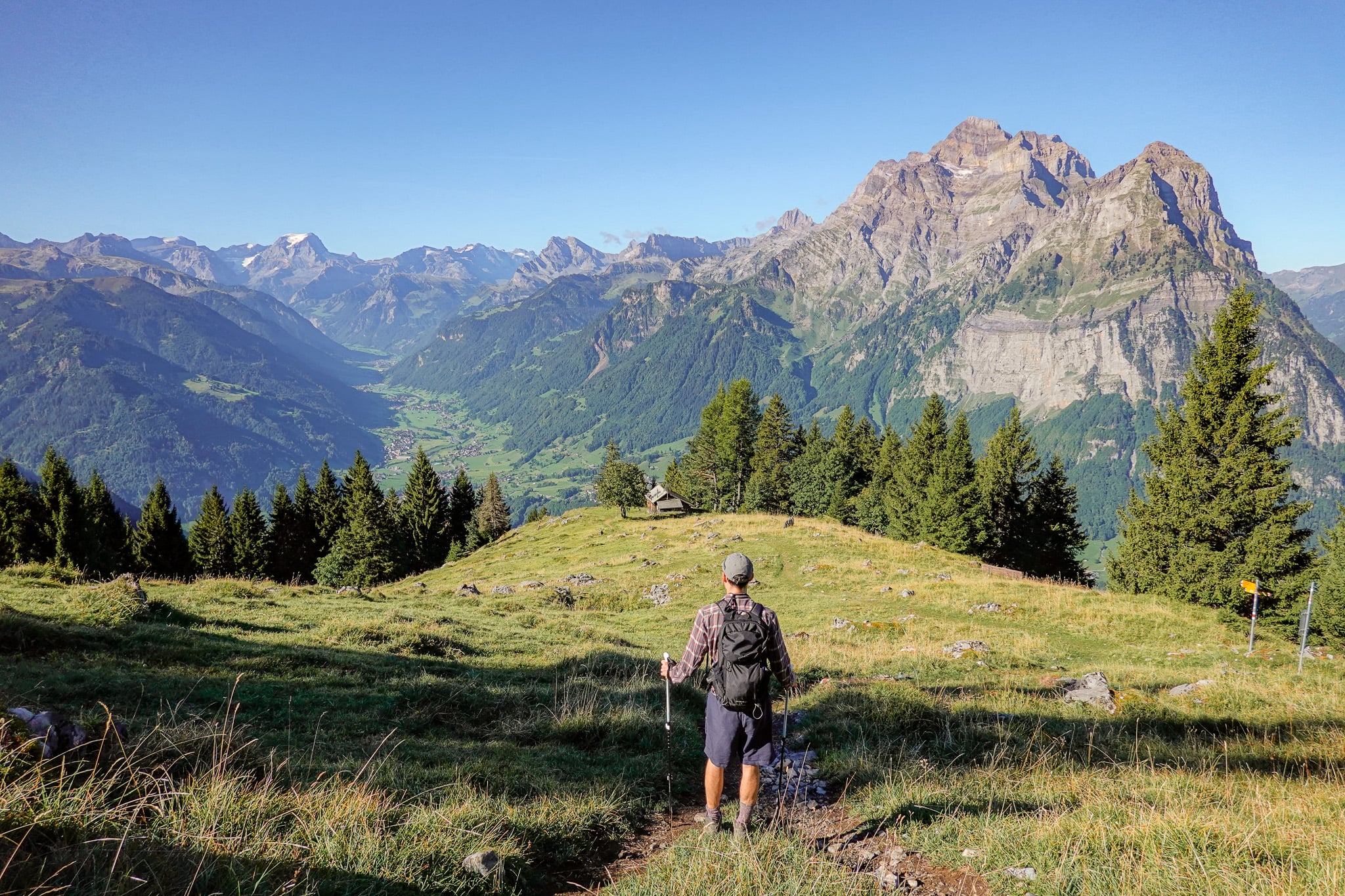 Dan looks at a valley surrounded by mountains on a hike called the Holzflue Rundweg