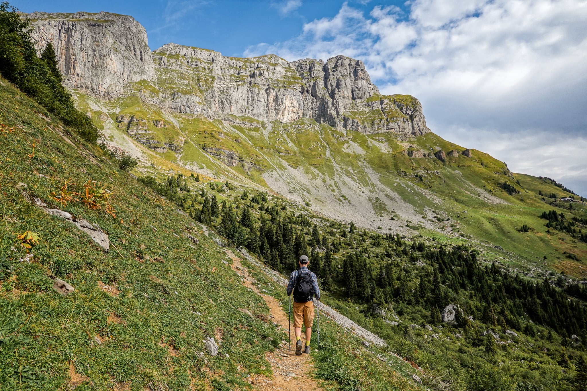 Dan walks on a trail amongst mountains during a hike called the Braunwald Panoramaweg