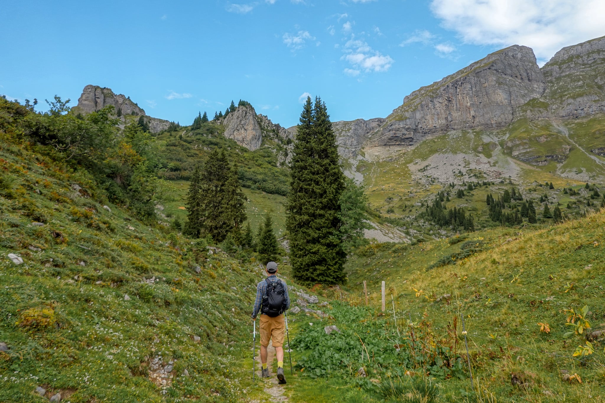 Dan walks on a trail towards mountains on a circular route called the Braunwald Panoramaweg