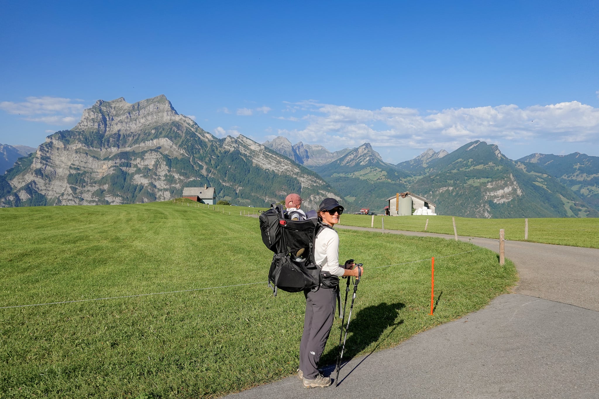 Beck with a child carrier backpack surrounded by mountains during the Schabziger Höhenweg