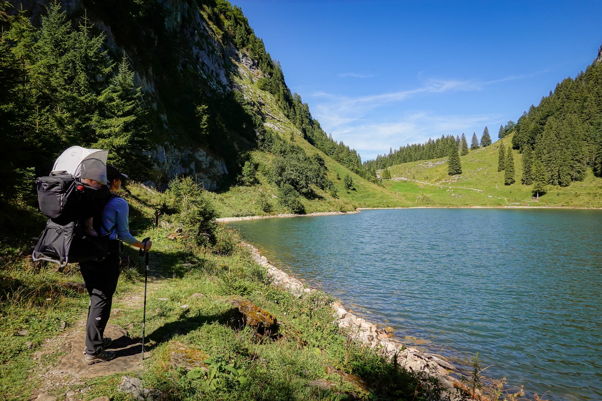 Beck stands by a lake during a loop walk called the Habergschwänd Talalpsee Hike